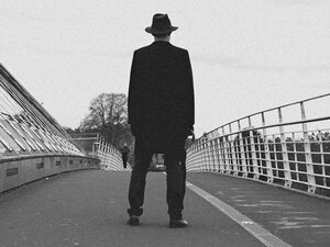 A man in a long dark coat.